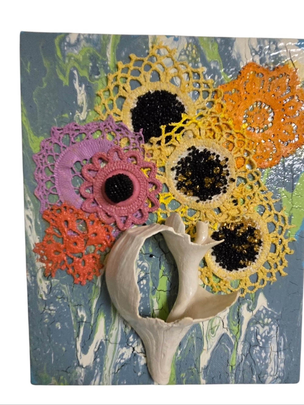 eclectic coastal  mixed-media 3D wall decor featuring crocheted flowers seashell